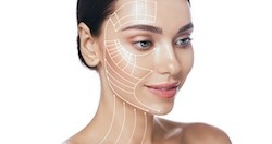 Portrait of a woman with a smooth, clear complexion, with lines drawn on her face and neck indicating areas for potential facial tightening or anti-aging treatments.
