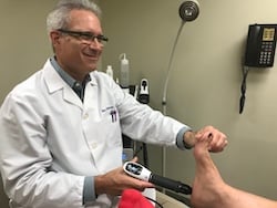Dr Marc Lederman Treating a Patient