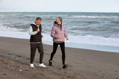 full-shot-senior-people-running-beach