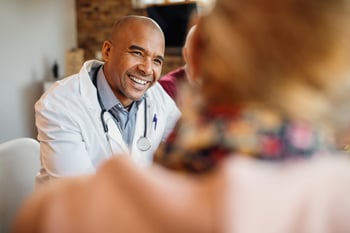 Smiling doctor talking to patient