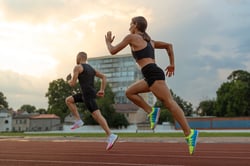 Man and woman running on track