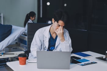 Stressed doctor on computer